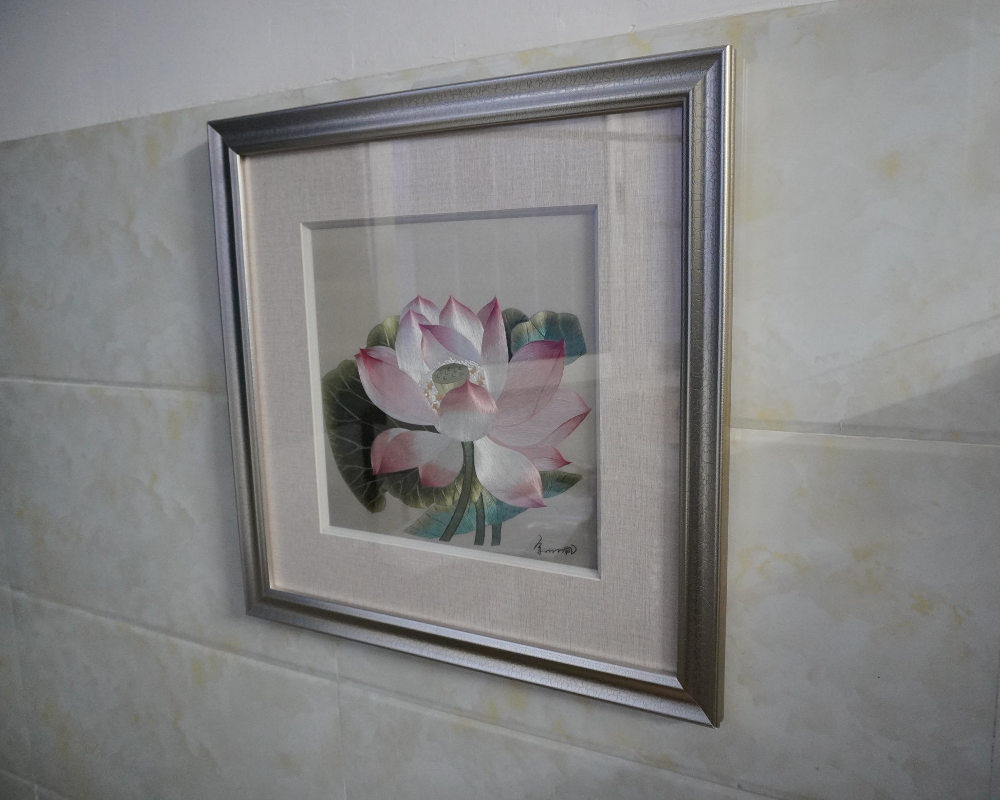 Side view of canton embroidery of Song Dynasty lotus painting. Hand-embroidered silk art in silver frame, 50.5cm square with glass.