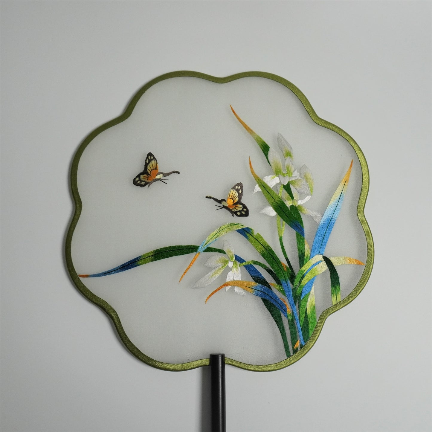 Close-up of hand-embroidered double-sided embroidery orchid and butterfly on silk gauze fan.