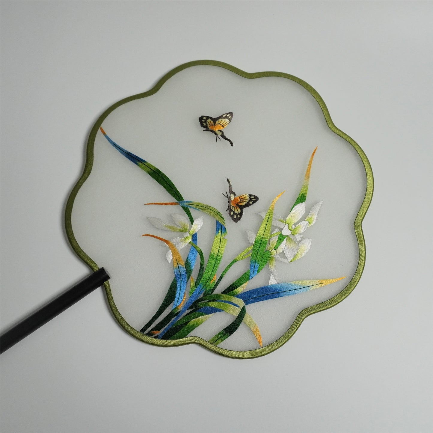 Front side of double-sided embroidery orchid and butterfly fan. Plum blossom shaped frame.