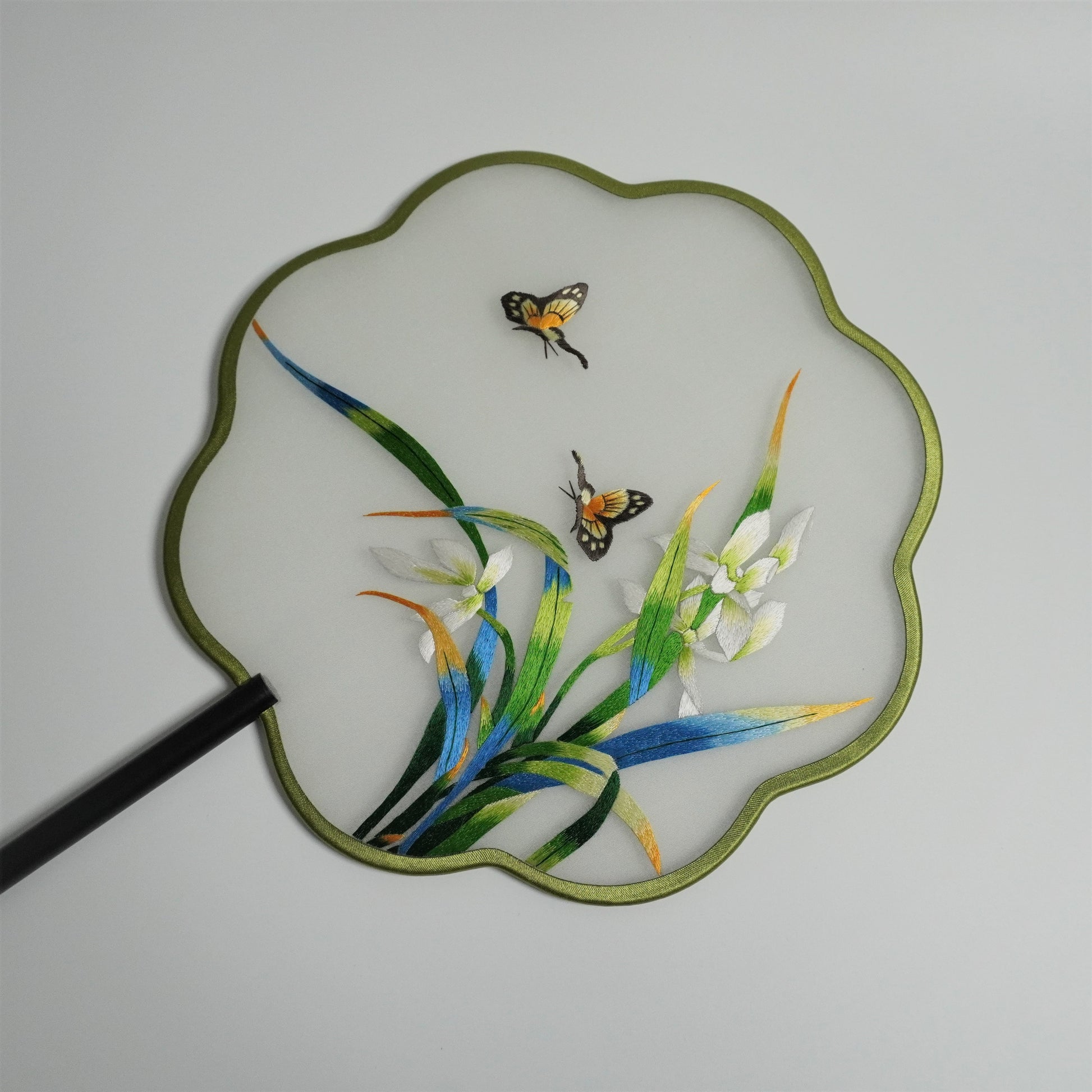 Front side of double-sided embroidery orchid and butterfly fan. Plum blossom shaped frame.