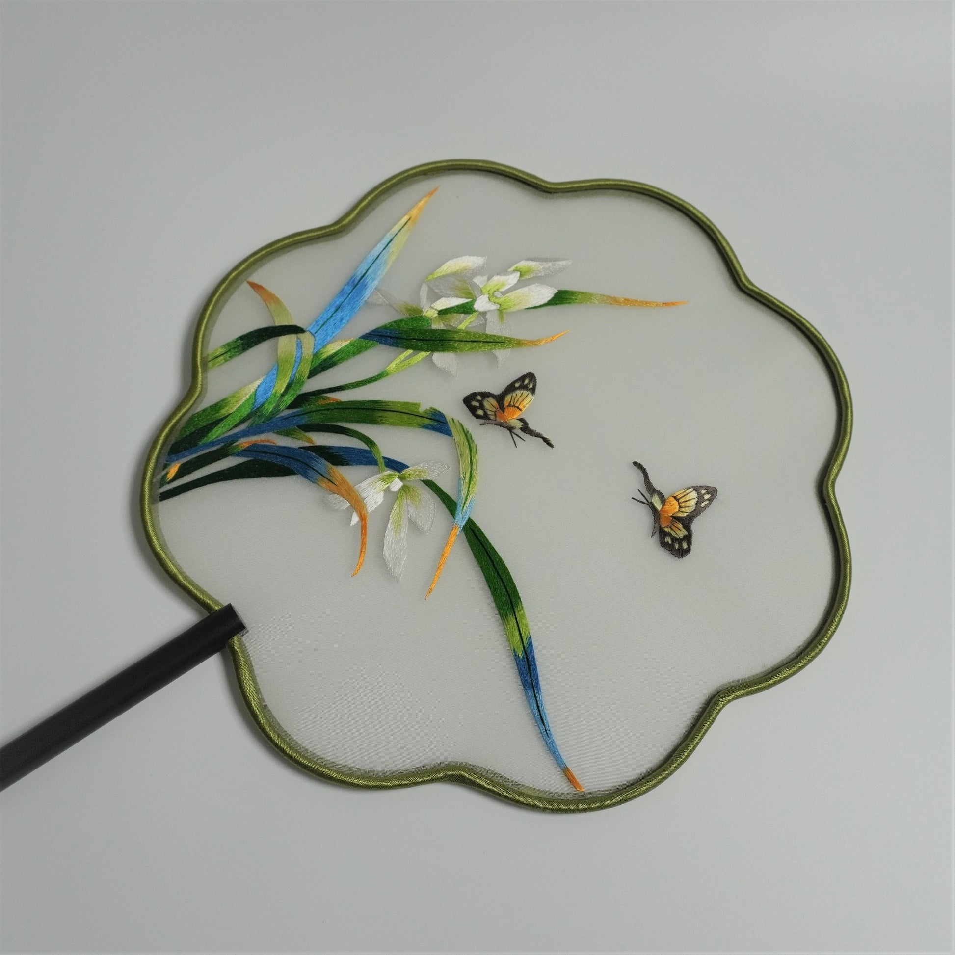 Back side of double-sided embroidery orchid and butterfly fan. Plum blossom shaped frame.