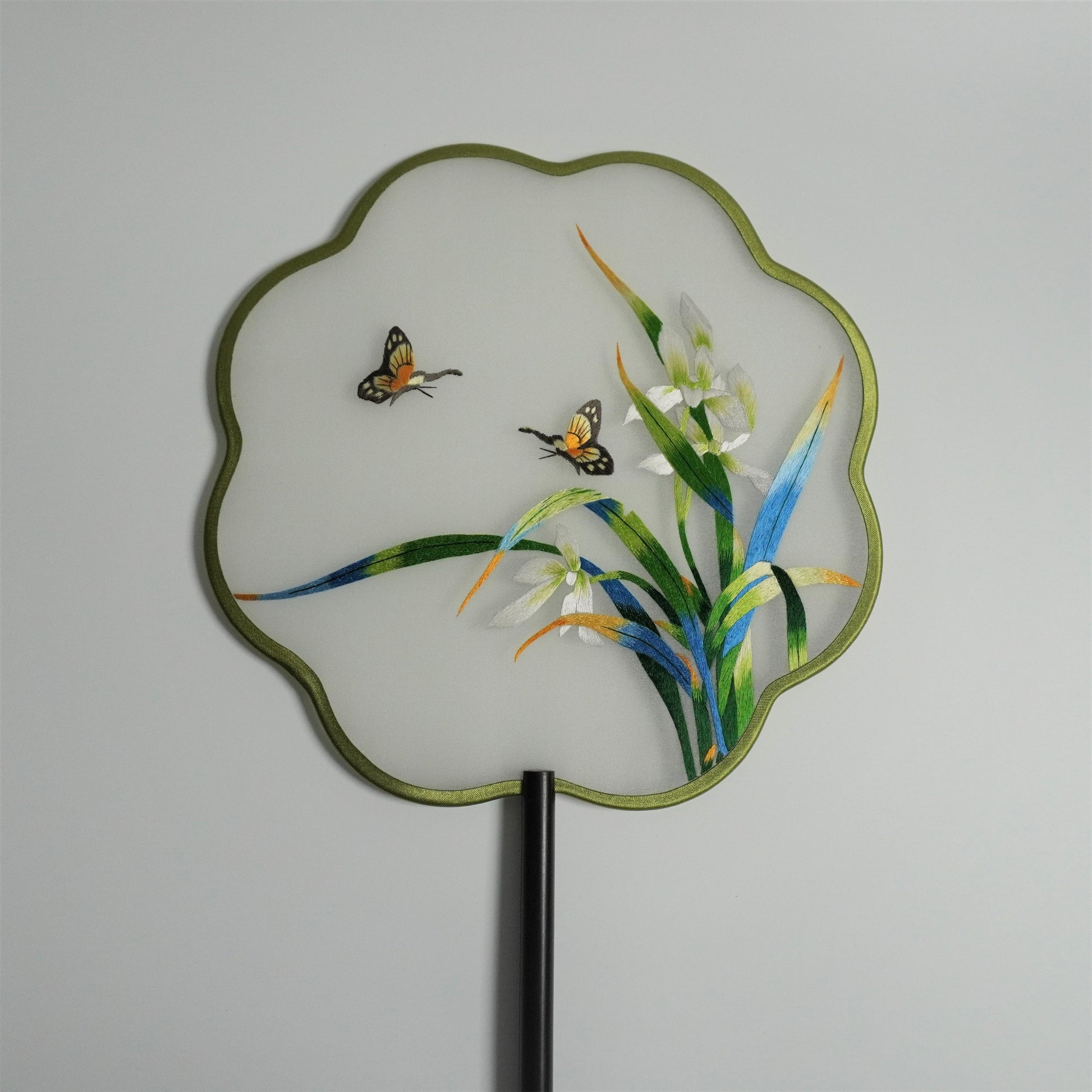 Hand-embroidered orchid and butterfly on silk gauze fan with plum blossom shaped frame.