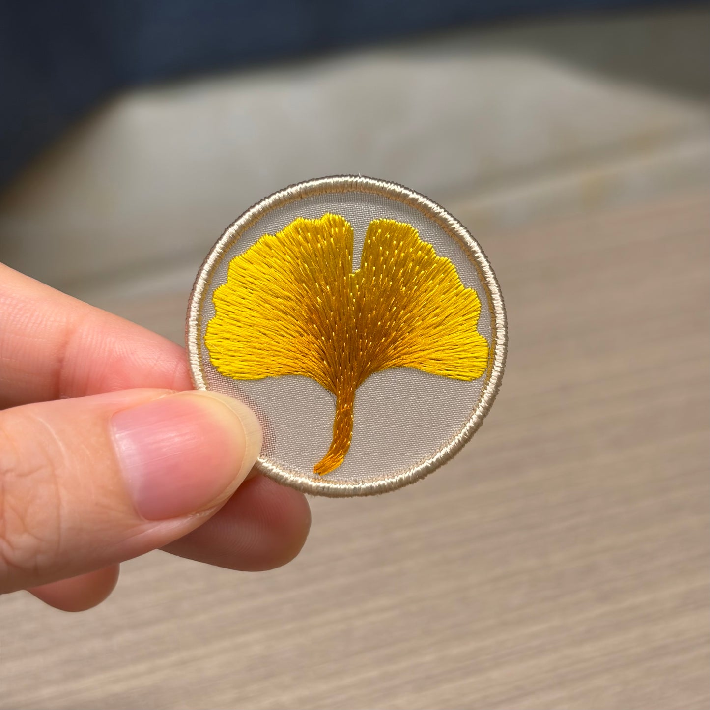 Close-up view of double-sided silk embroidered ginkgo leaf showing delicate handmade stitches