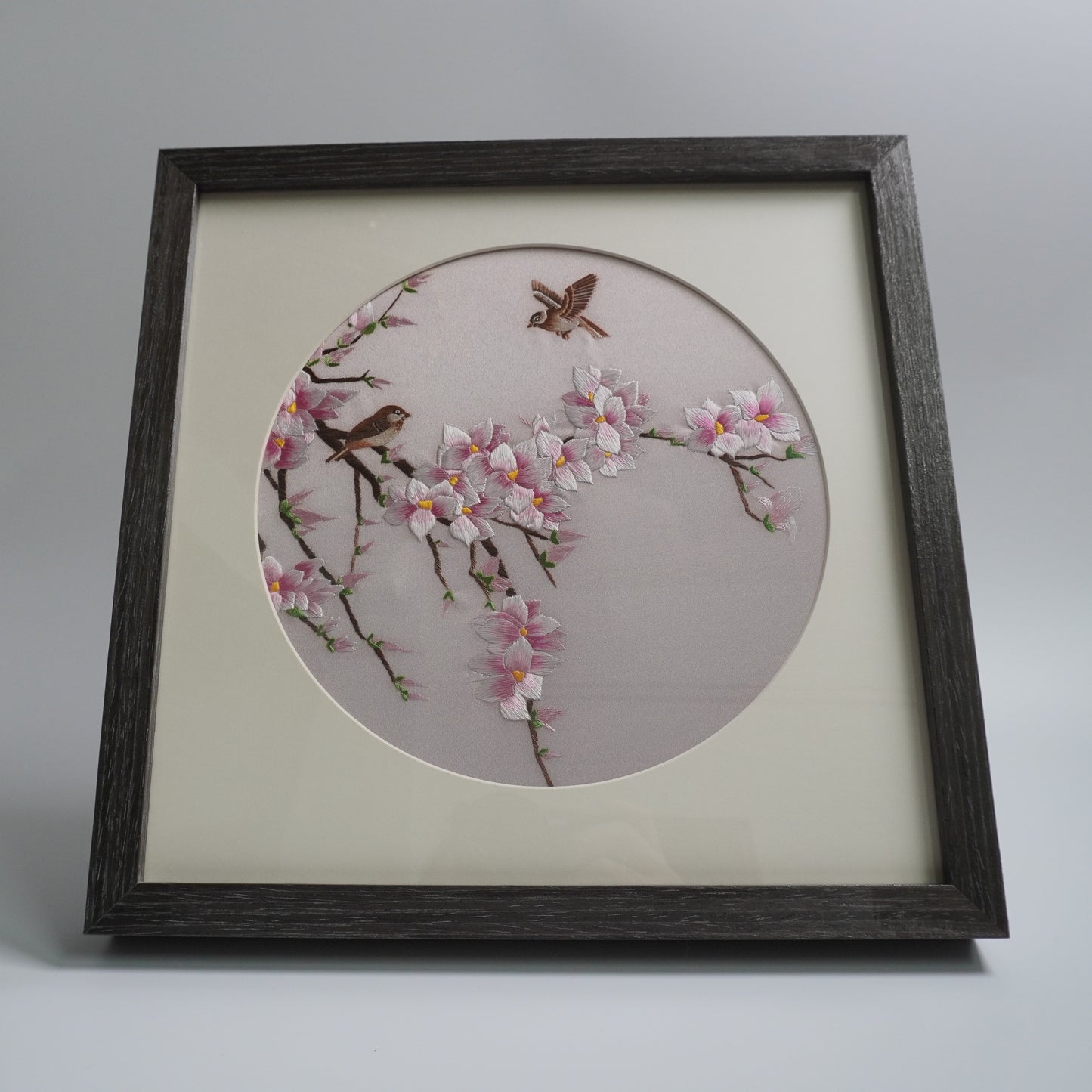agnolia-birds round silk embroidery with mat and acrylic glazing, 10 inches.