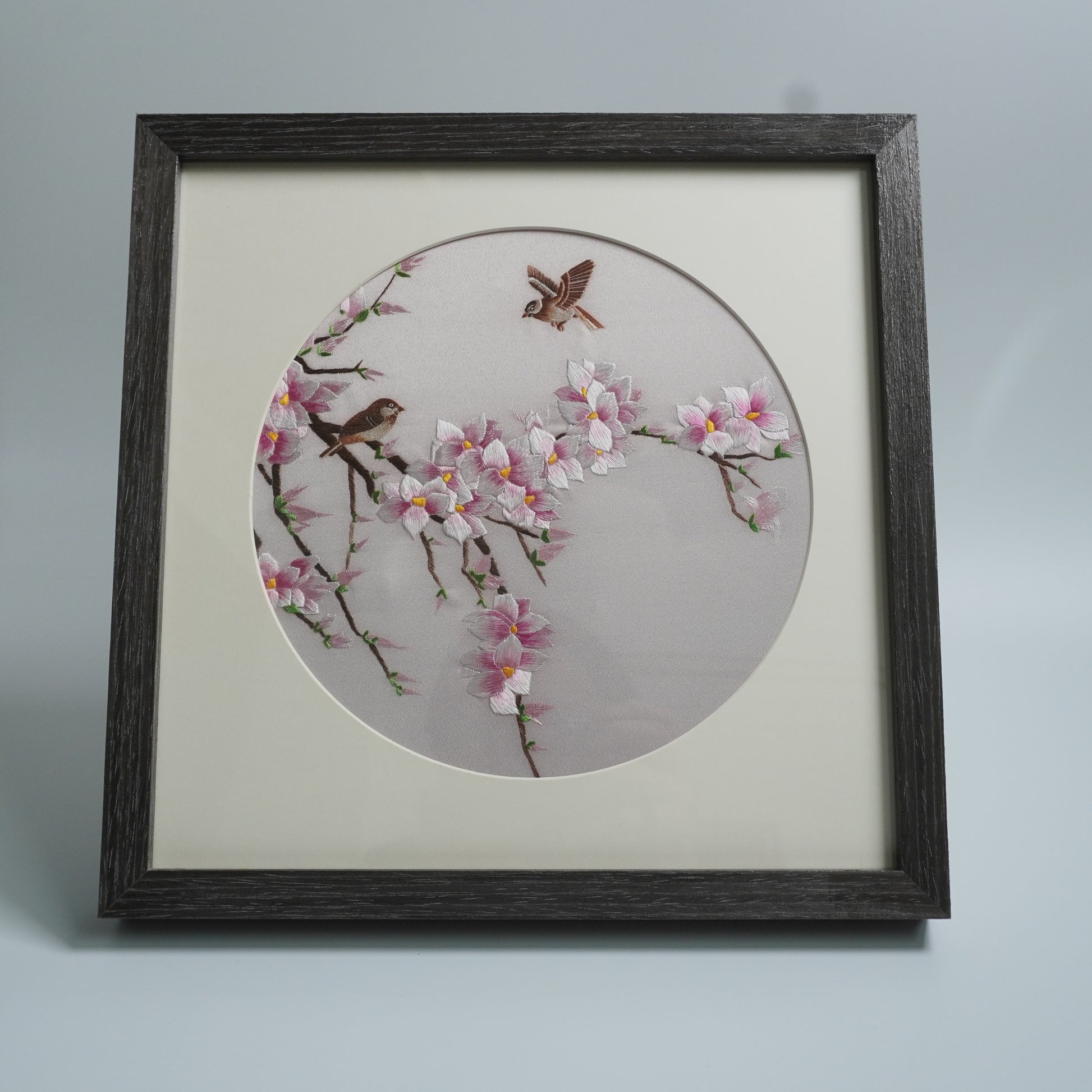 Hand-embroidered magnolia and birds in black wood